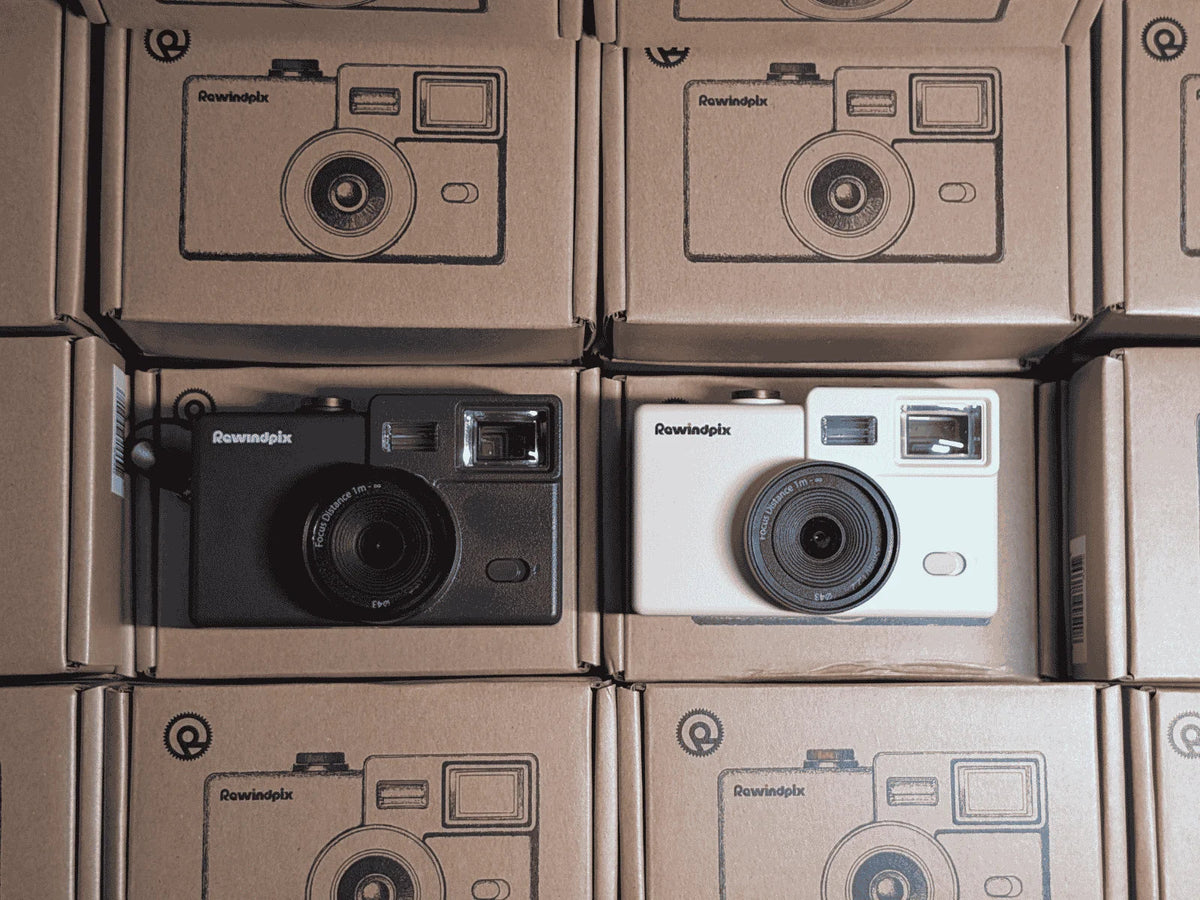 Black and white Rewindpix cameras in cardboard packaging